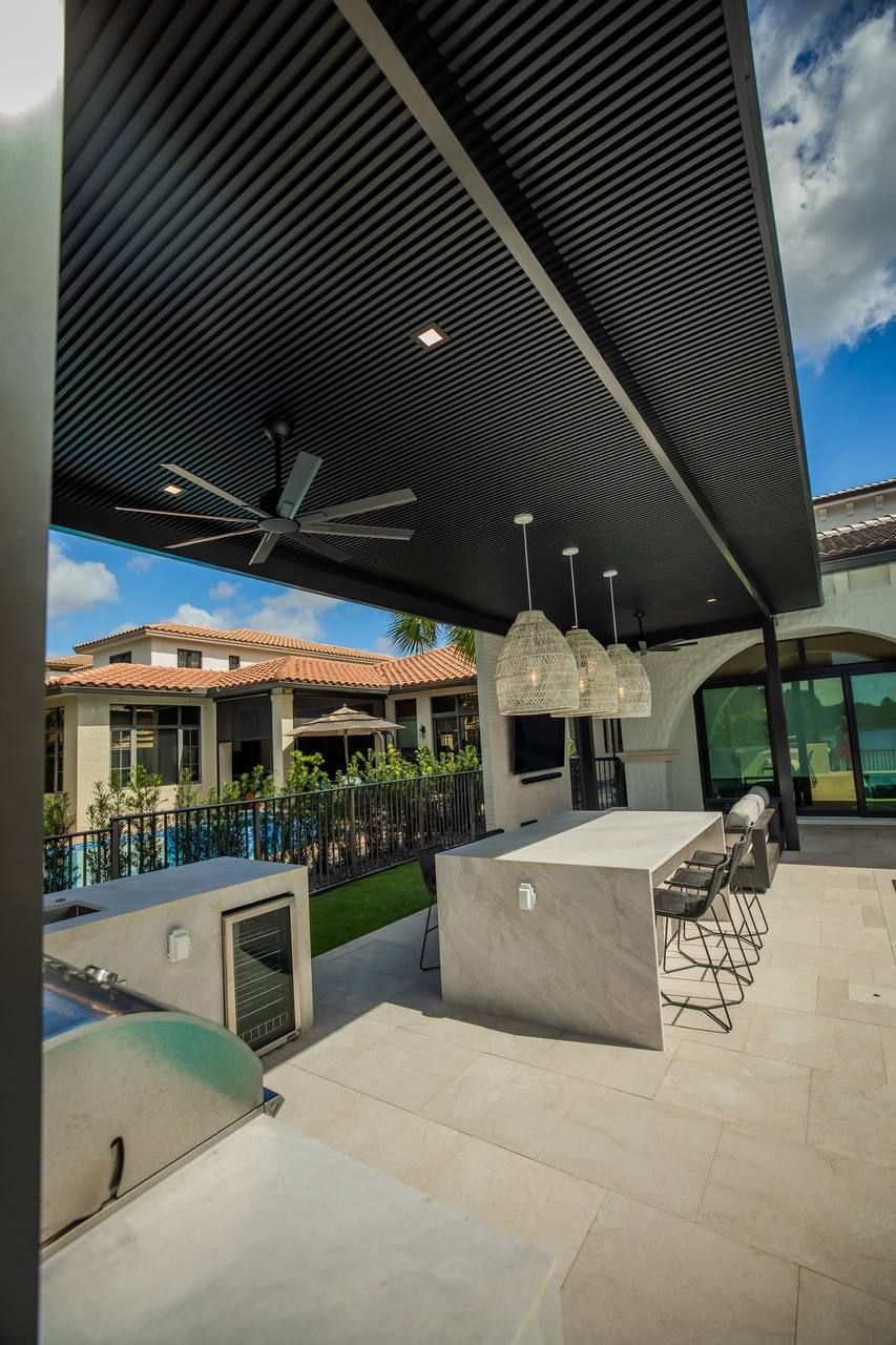 Pergola with ceiling fan over an outdoor kitchen