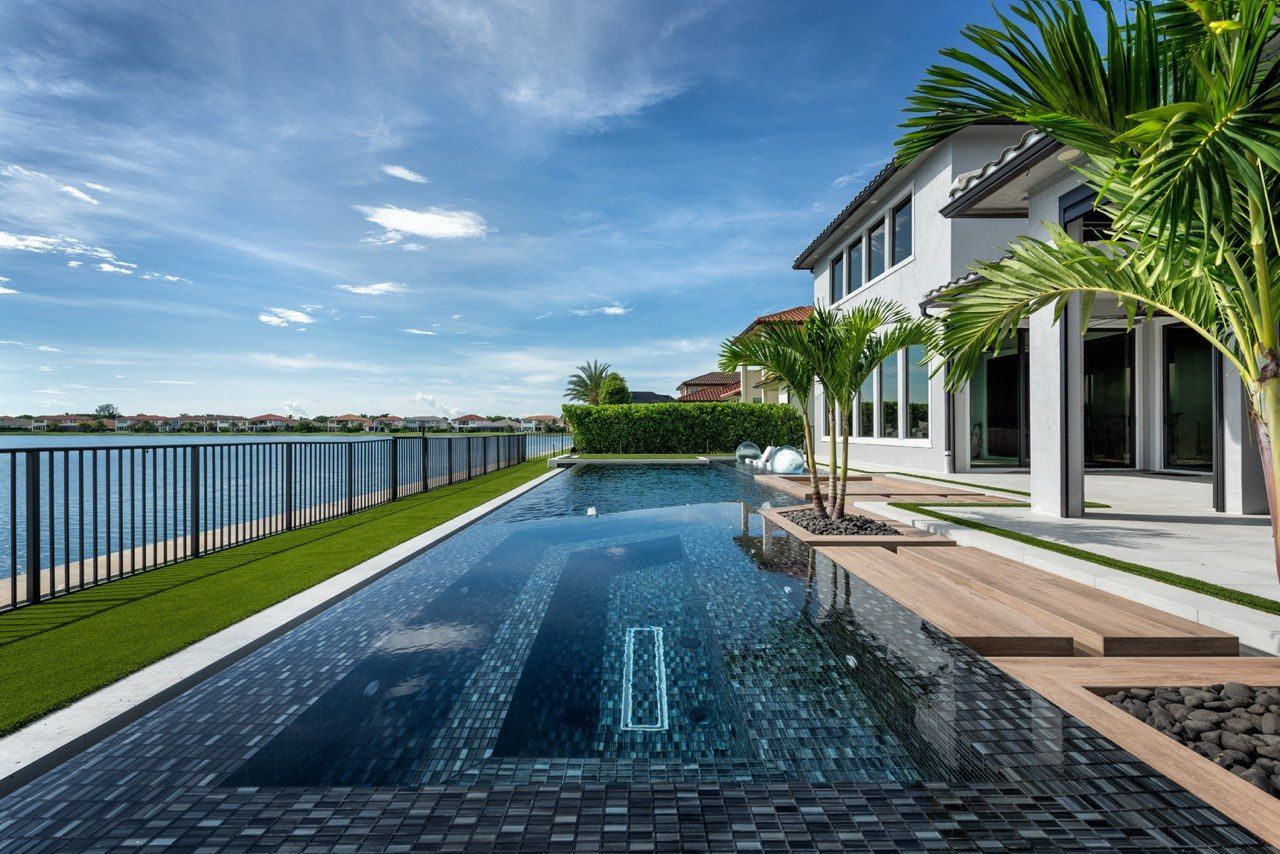 Long pool with the home and blue sky behind it